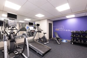 A gym with treadmills, elliptical machines, and a wall with dumbbells. - Holiday Inn Express Hotel & Suites Danbury - I-84 by IHG (Danbury)