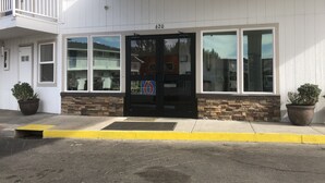 A building with a black door, numbered 620, and large windows. - Motel 6 Pendleton, OR - West (Pendleton)