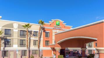 A Holiday Inn Express building with a clear blue sky.
