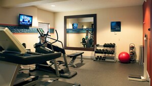 A hotel fitness center with treadmills, a mirrored wall, a television, and a rack of dumbbells. - Hampton Inn Tulsa-Sand Springs (Tulsa)