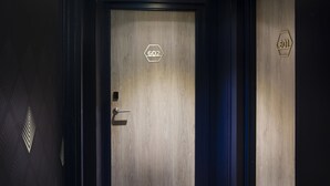A hotel room door with a number "602" and a "60L" sign, indicating room size.