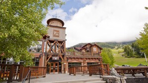 A rustic wooden building with a balcony and a sign reading "Dusty's". - Legends Whistler, by Lodging Ovations (Whistler)