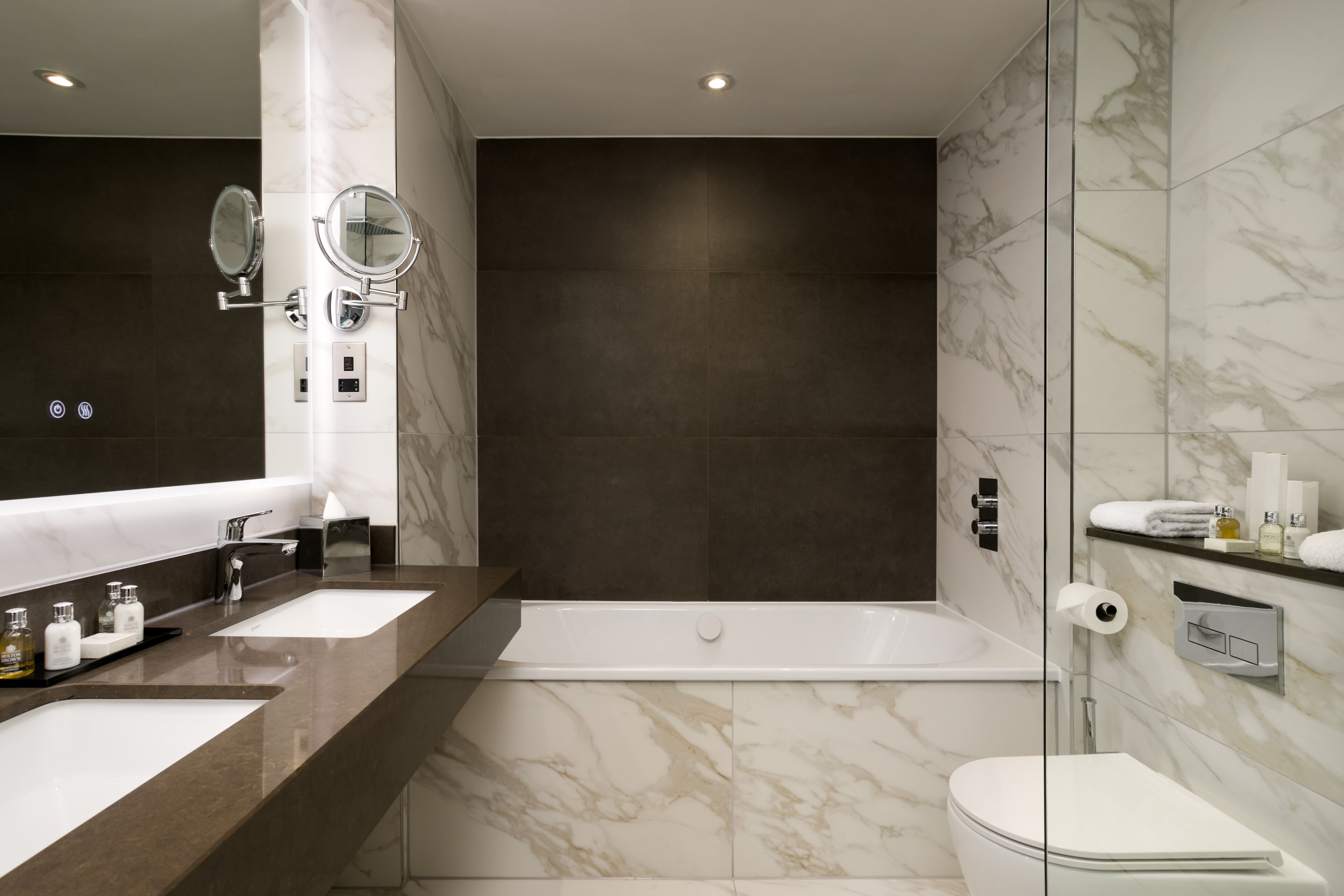 designer toiletries, hair dryer, bathrobes, slippers