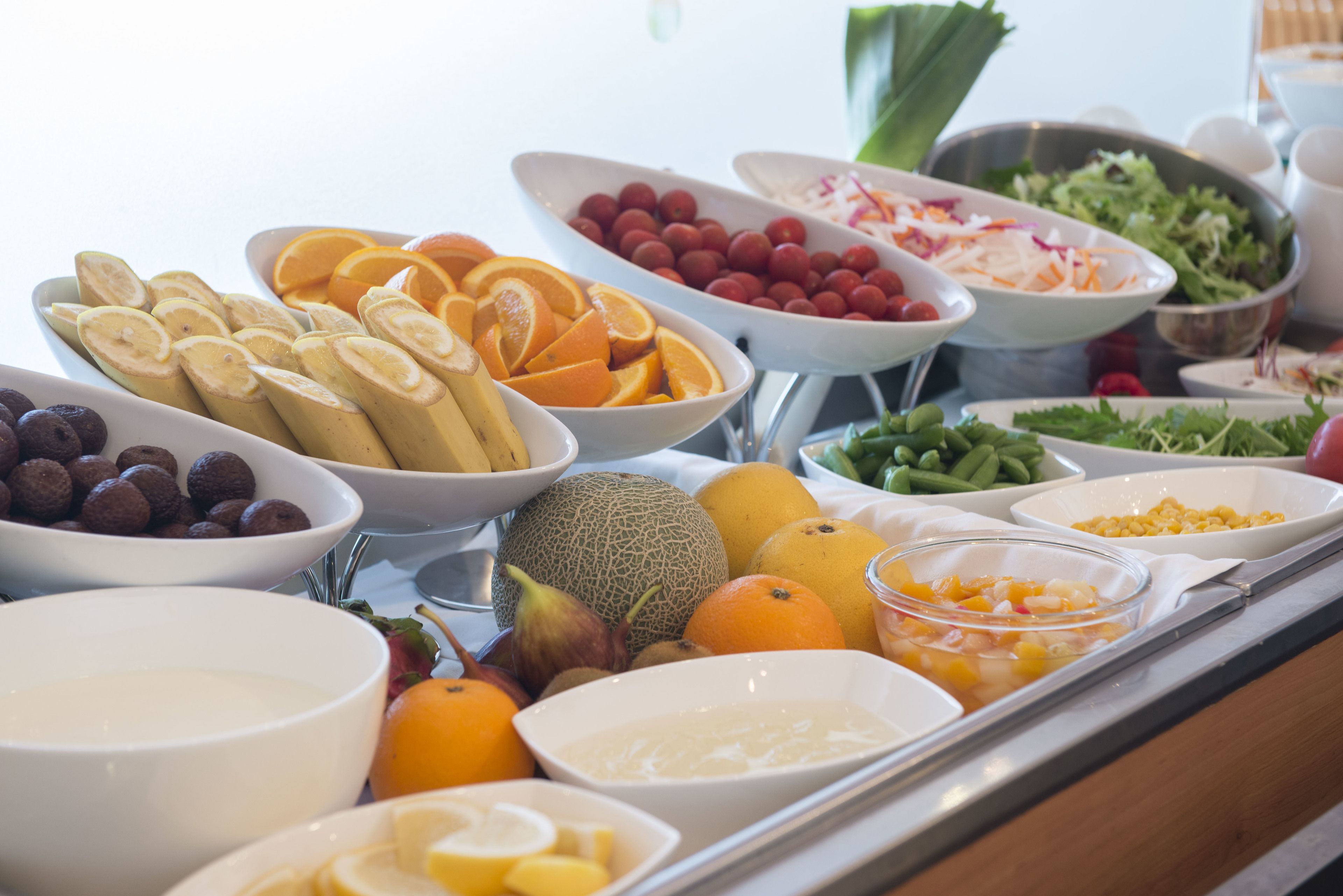 A buffet with various fruits, vegetables, and dips.