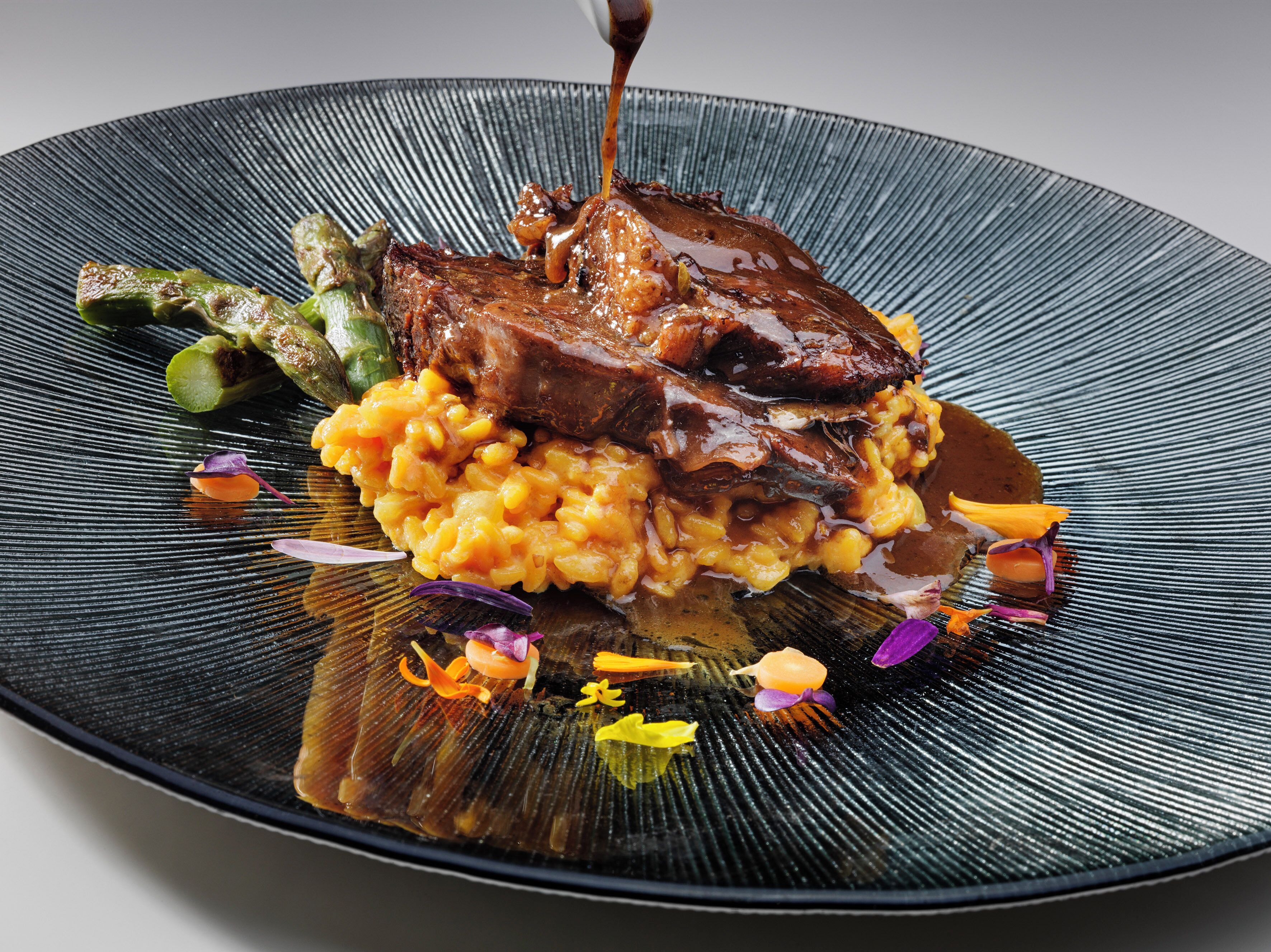 A plated dish with meat and vegetables.