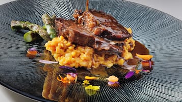 A plated dish with meat and vegetables.