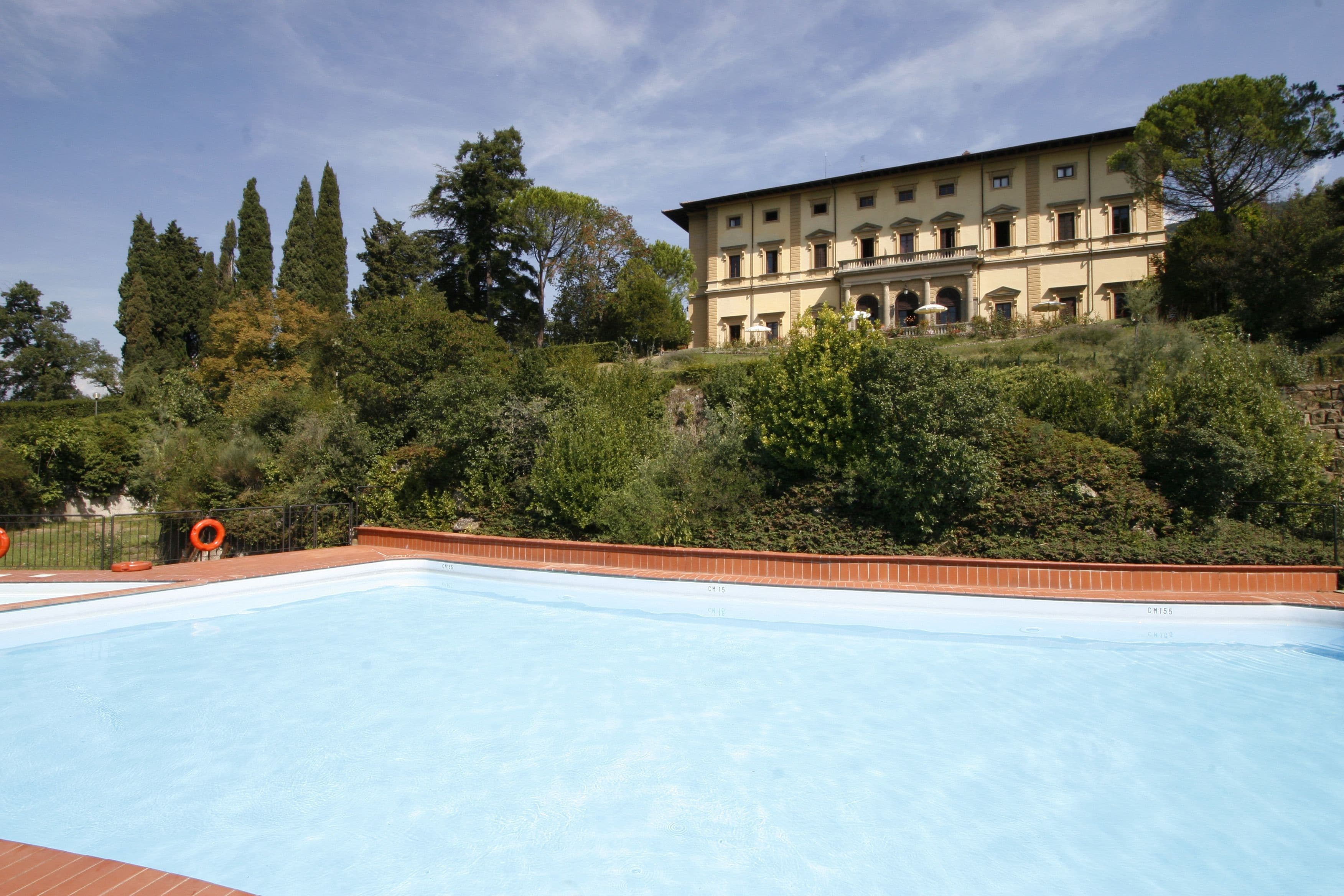A swimming pool with a building in the background.