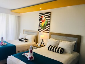 Deluxe Room, Garden View | Minibar, desk, blackout drapes, bed sheets