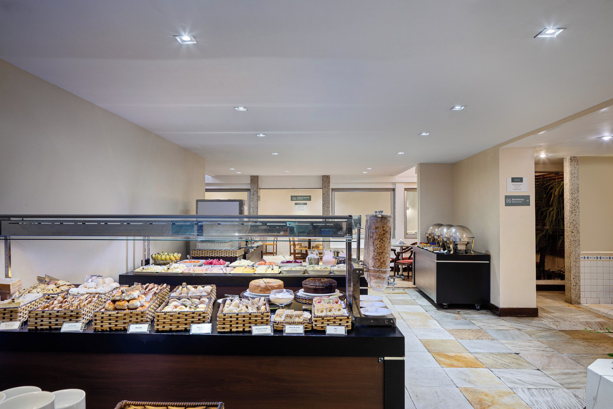 A buffet area with various food items and a coffee station.