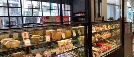 A refrigerated display case in a store with various packaged goods and beverages.