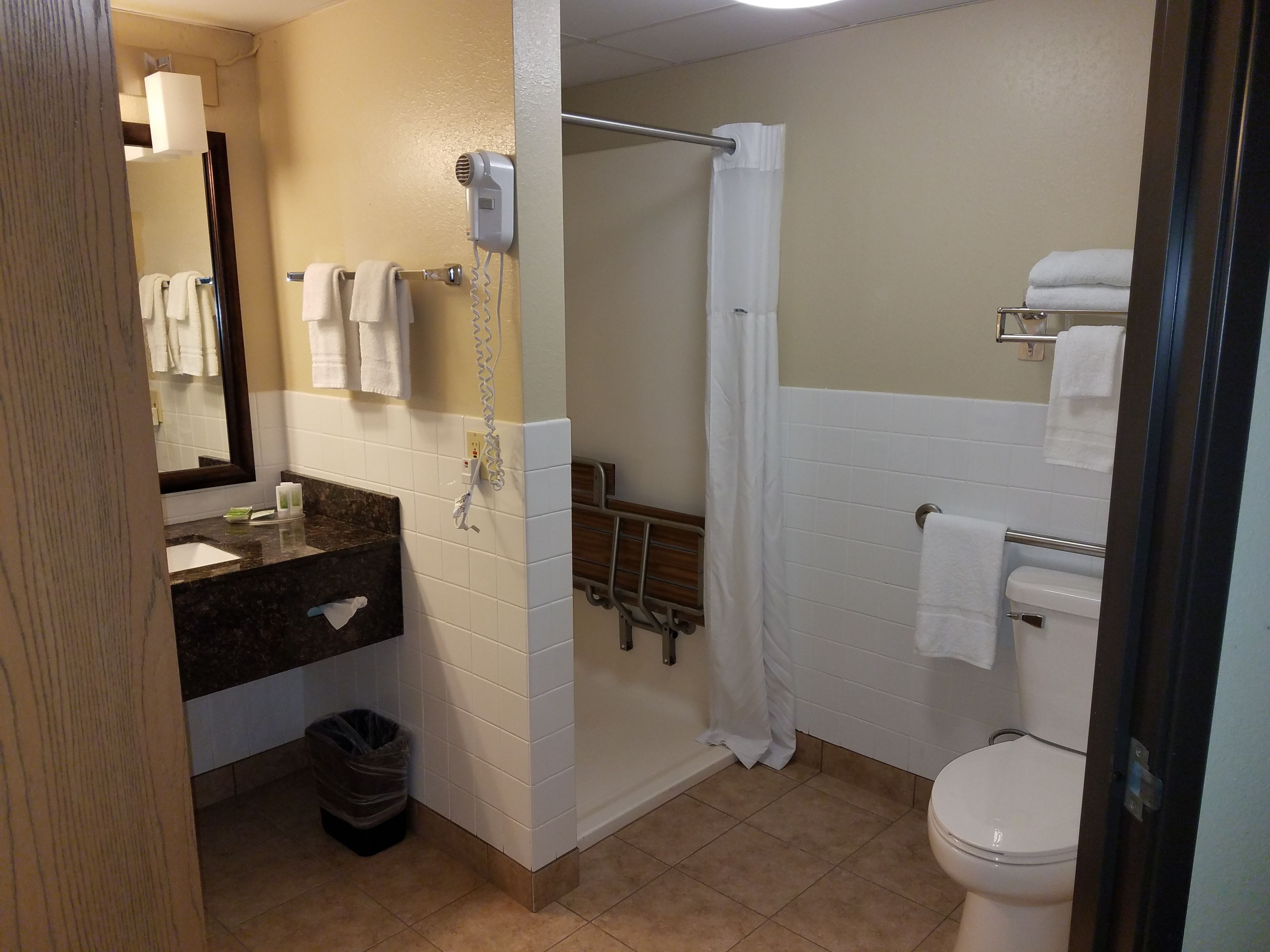Un baño con ducha, inodoro y lavabo.