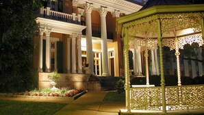 A classical building with a central entrance flanked by columns, a covered gazebo, and a well-maintained garden. - Embassy Suites by Hilton Nashville at Vanderbilt (Nashville)