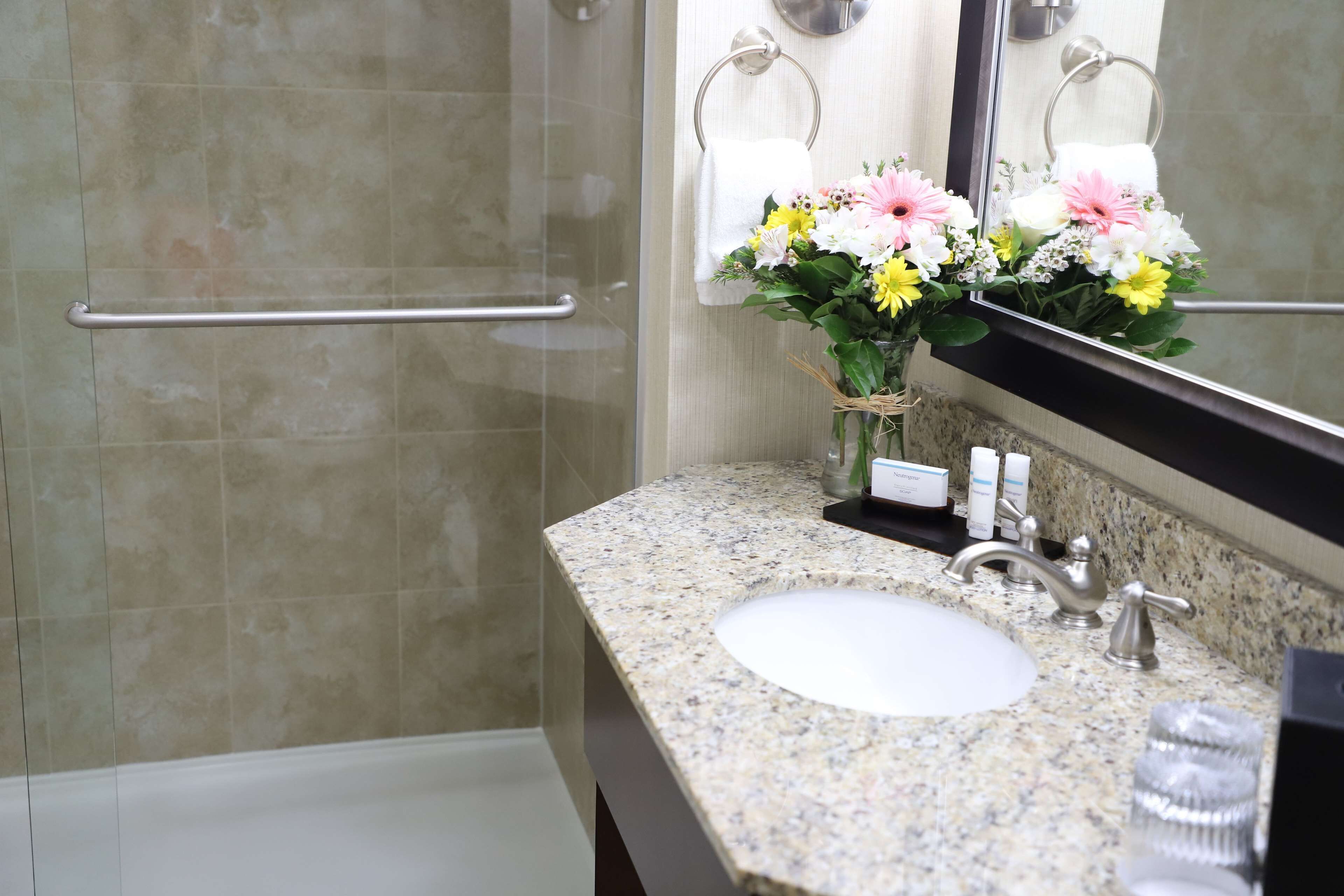 combined shower/bathtub, designer toiletries, hair dryer, towels