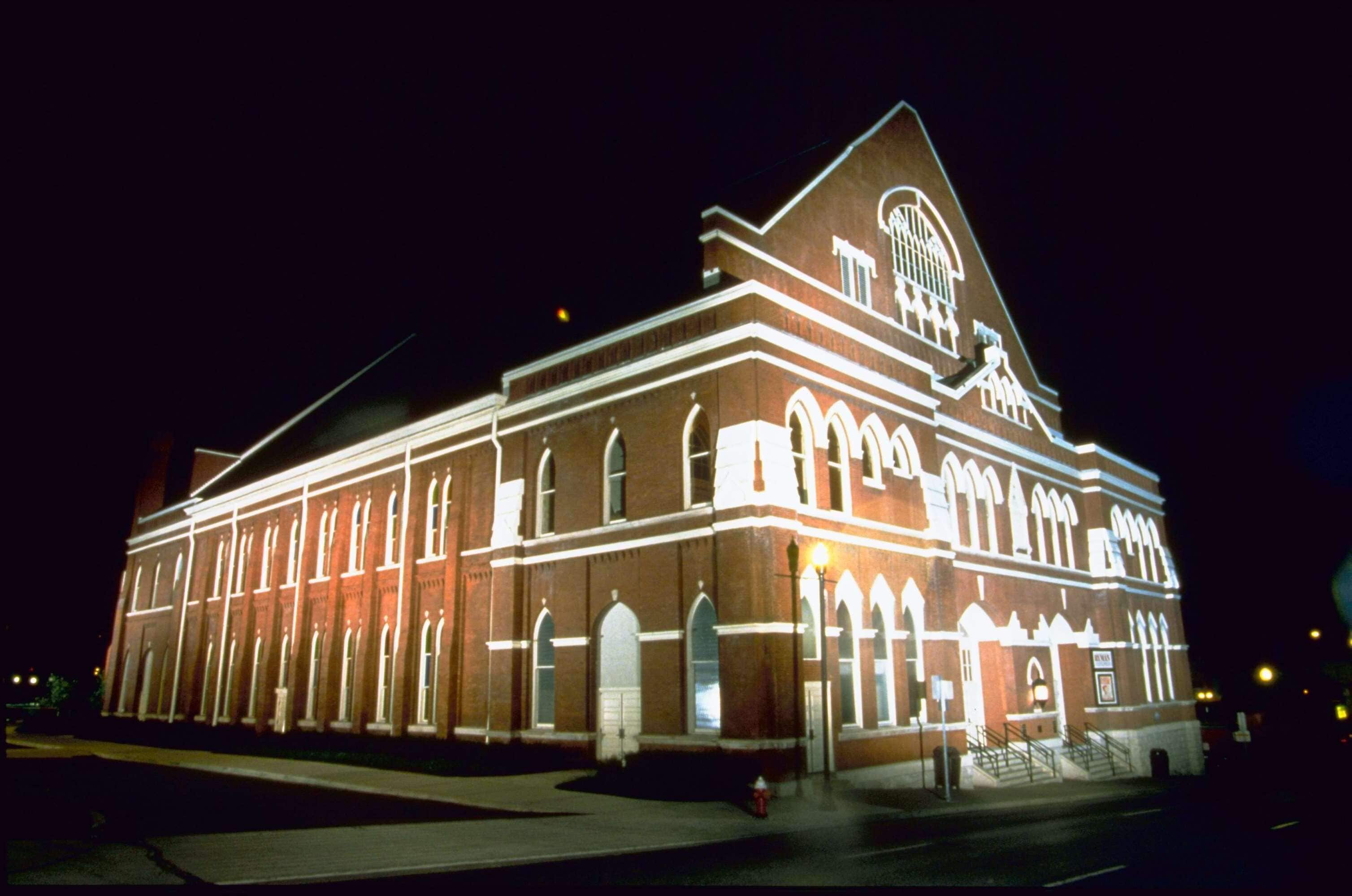 A large, historic building with a prominent arched entrance and a clock tower.
