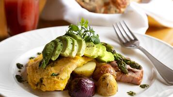 A plate with food including avocado, asparagus, and potatoes.