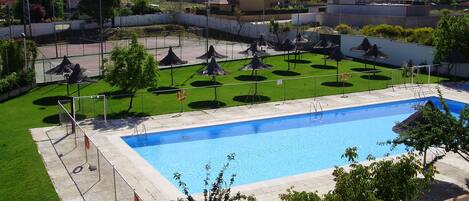 Seasonal outdoor pool, open noon to 8:30 PM, pool umbrellas