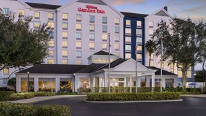 A Hilton Garden Inn with a modern design, featuring multiple floors and a well-lit entrance. - Hilton Garden Inn Orlando at SeaWorld (Orlando)