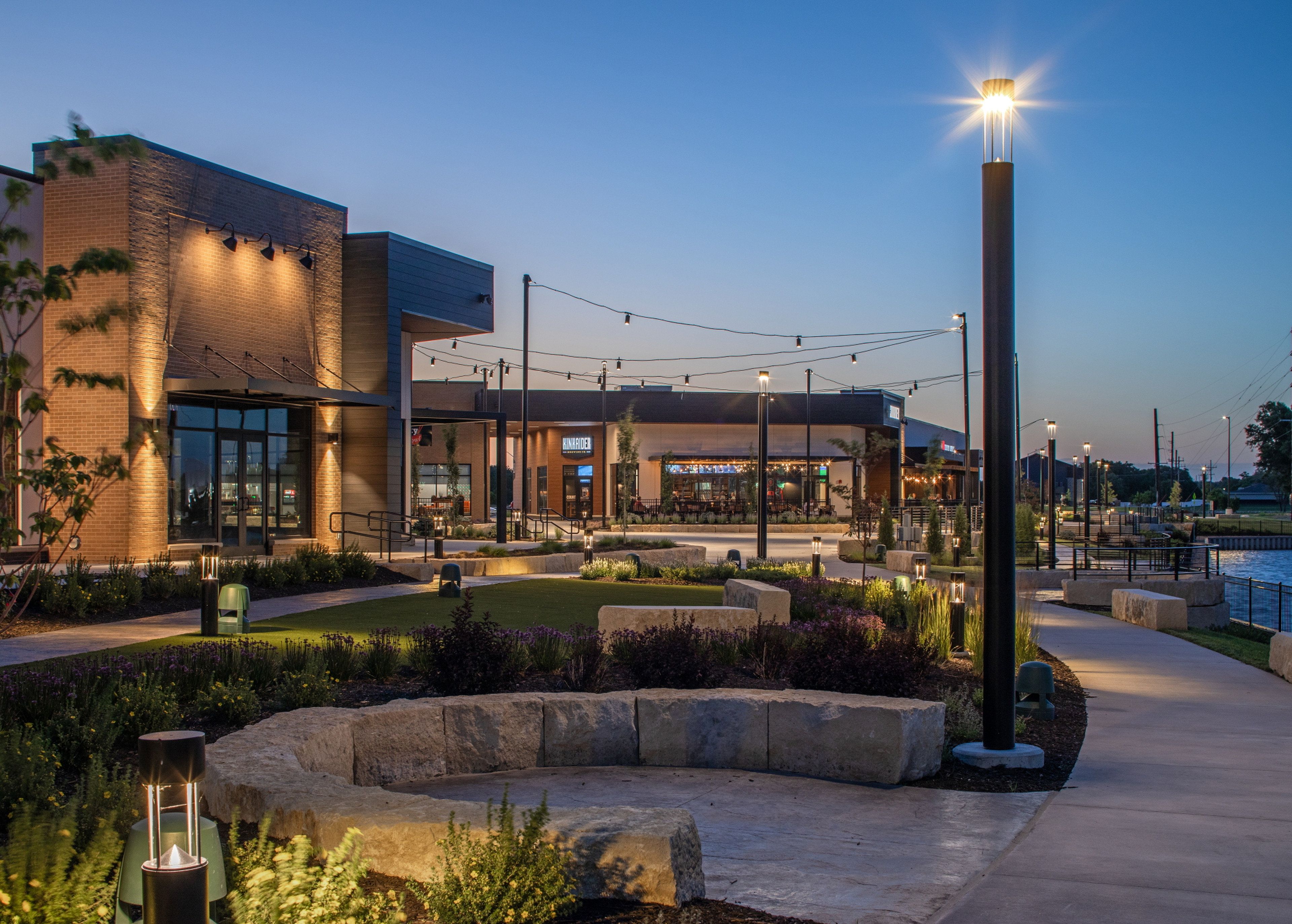 A modern building with a restaurant named 'HINRIDER' and outdoor seating.