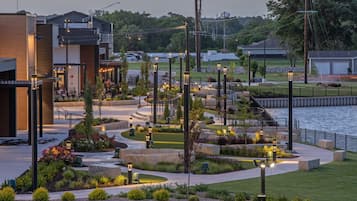 A landscaped outdoor area with pathways, seating, and a water feature.