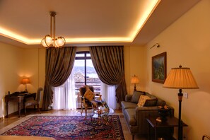 Relax in this stylish living room with a comfortable sofa, armchair, and elegant rug.