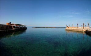 Enjoy a serene waterfront view from this tranquil setting, featuring a restaurant or café and a scenic promenade.