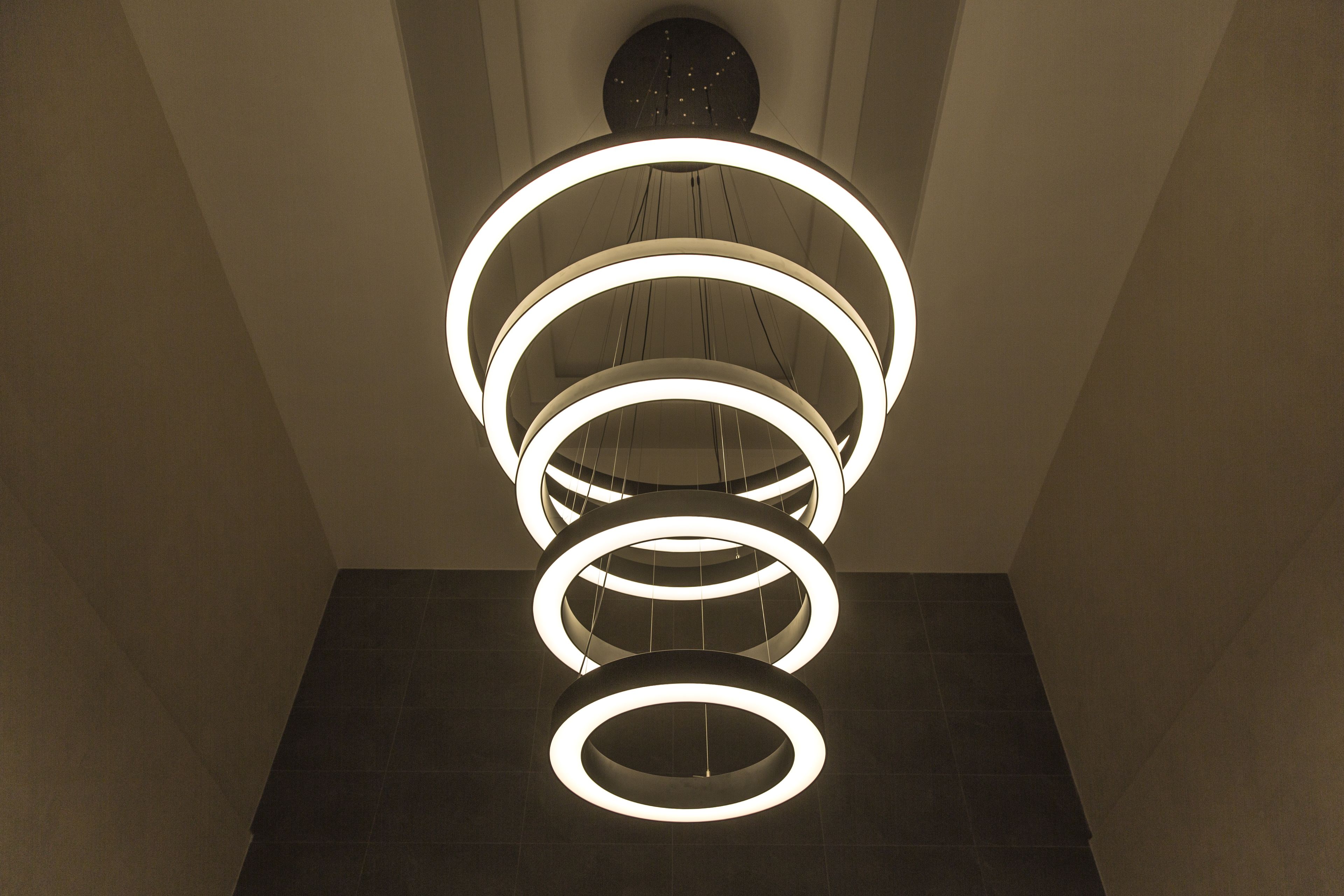 A modern chandelier with multiple circular light fixtures.