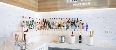 A bar area with a sign reading "THE VIEW PLATINUM" and a wall of various liquor bottles.