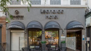 The exterior of the Leonardo Hotel with a closed shutter on the left and a visible restaurant entrance. - Leonardo Hotel Antwerp (Antwerp)