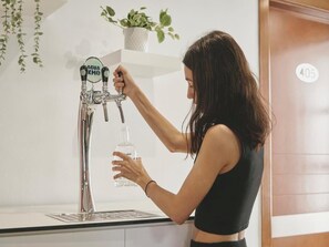 Guests can enjoy a modern kitchen with a sleek countertop and a convenient tap.