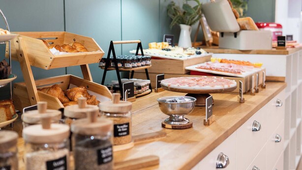 A breakfast buffet with various food items and condiments. - Tres Torres Atiram Hotel (Barcelona)
