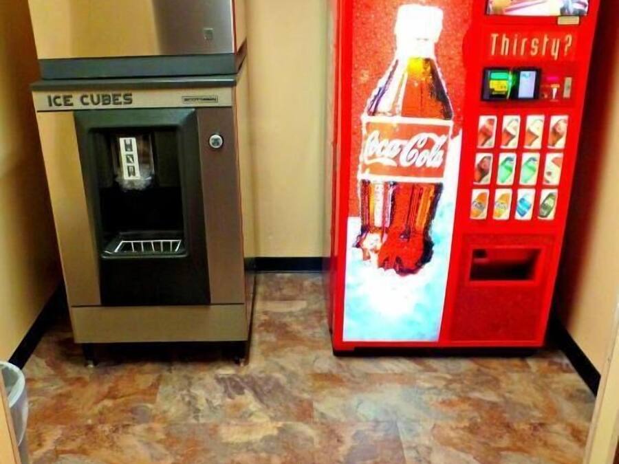 A vending machine with a Coca-Cola logo and a machine for making ice cubes.