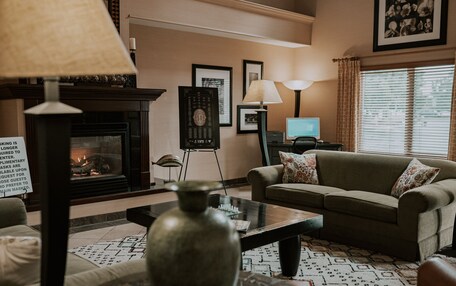 A living room with a fireplace, a sofa, a coffee table, and a television.