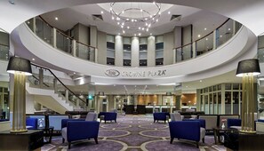 A hotel lobby with a circular layout, a reception desk, and seating areas. - Crowne Plaza Belfast by IHG (Belfast)
