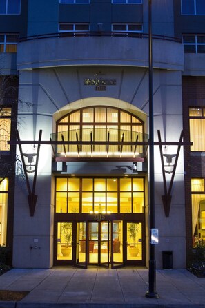 A hotel entrance with a double door, a sign indicating it's a hotel, and a visible outdoor seating area. - Residence Inn by Marriott Portland Downtown/RiverPlace (Portland)