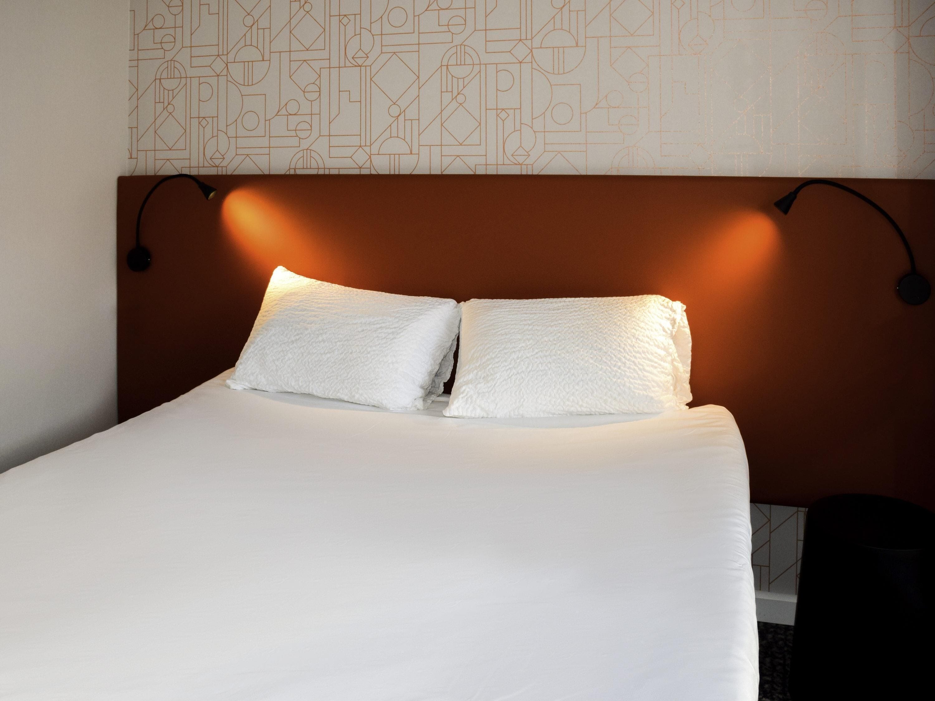 Premium bedding, desk, laptop workspace, blackout drapes