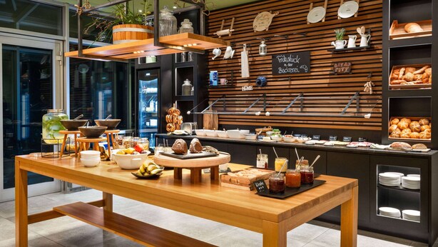 Un buffet de petit-déjeuner proposant une variété d’aliments et une table en bois.