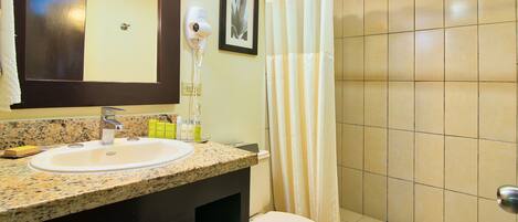 A bathroom with a sink, toilet, and shower.