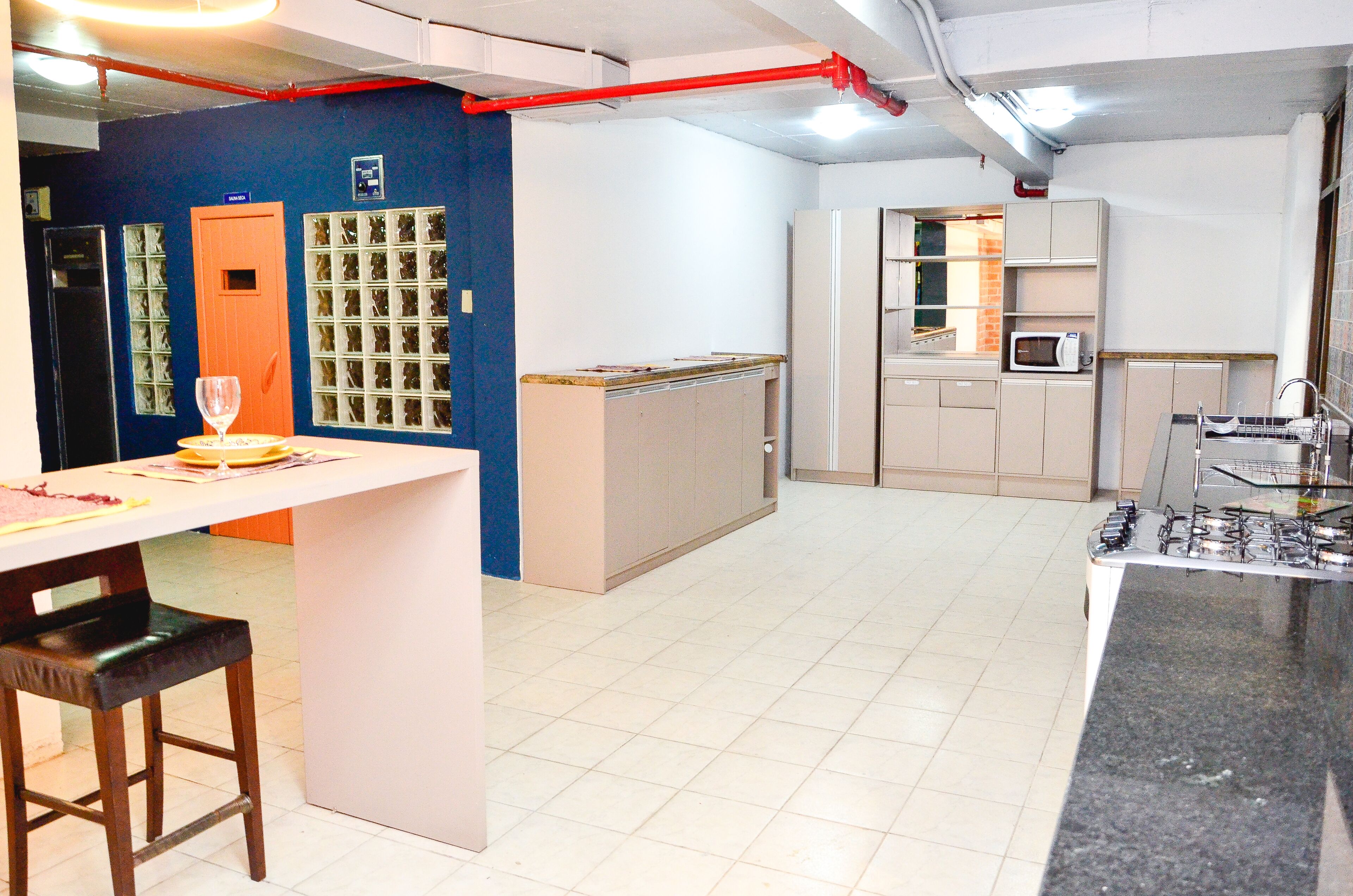 A modern kitchen with a central island, a microwave, and a sink.