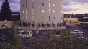 A hotel with a cylindrical tower, multiple windows, and a sign indicating it is a hotel. - Perugia Park Hotel (Perugia)