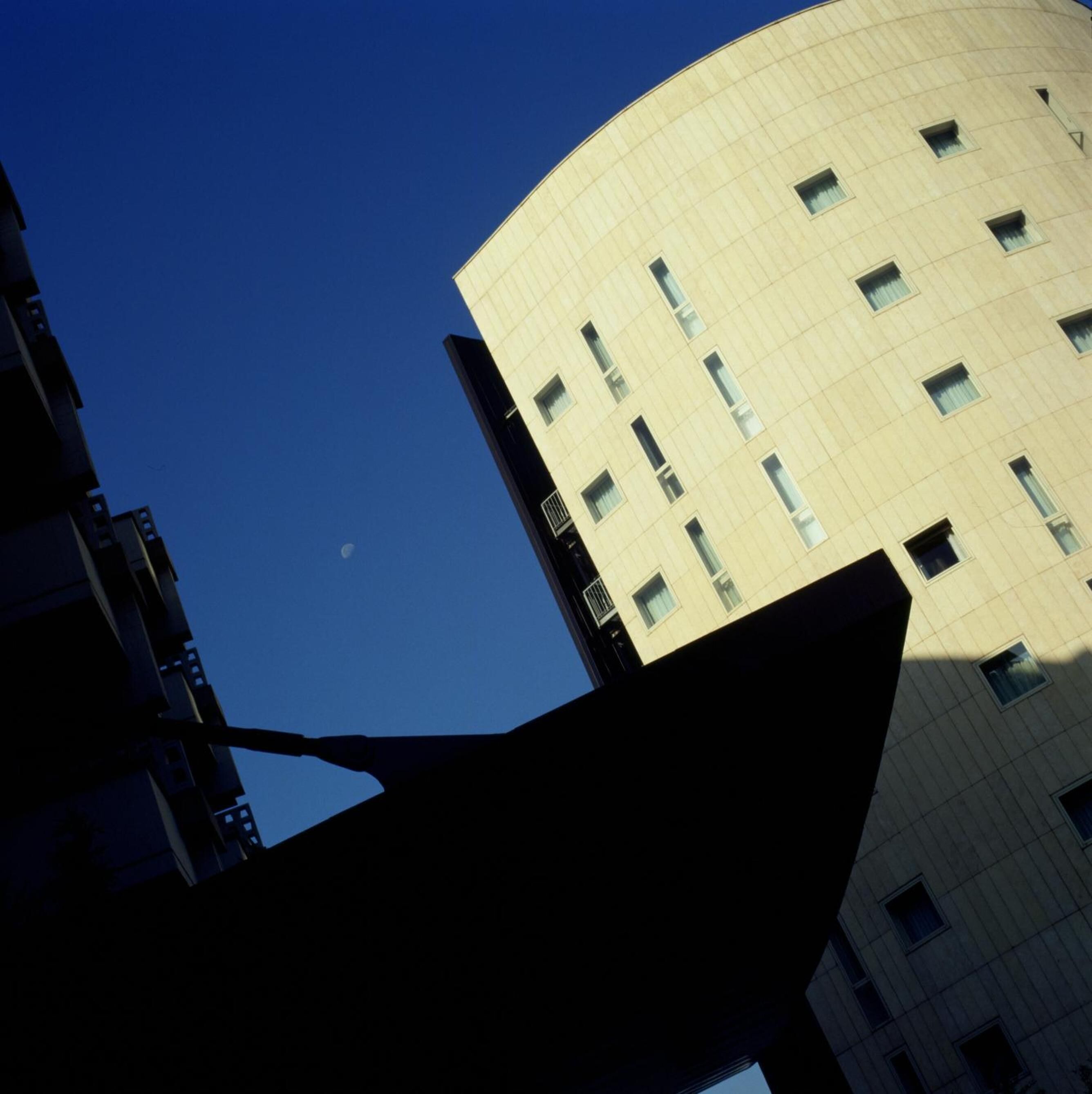 A high-rise building with a curved facade and multiple windows.