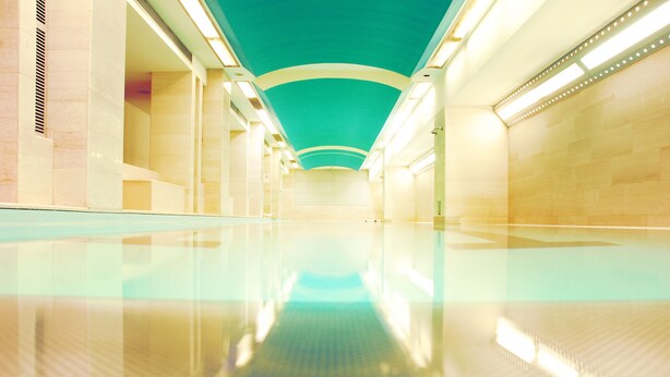 A modern, empty corridor with a reflective floor and a teal ceiling. - Perugia Park Hotel (Perugia)