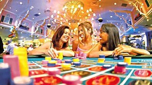 A group of people playing a board game at a casino.