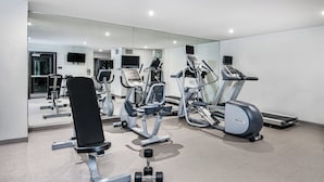 A gym with exercise equipment, including treadmills and weight machines.