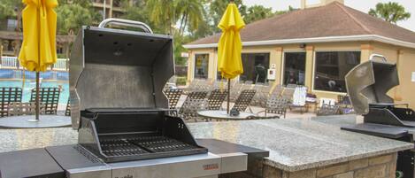 An outdoor grill area with a stone countertop and a commercial infrared grill.