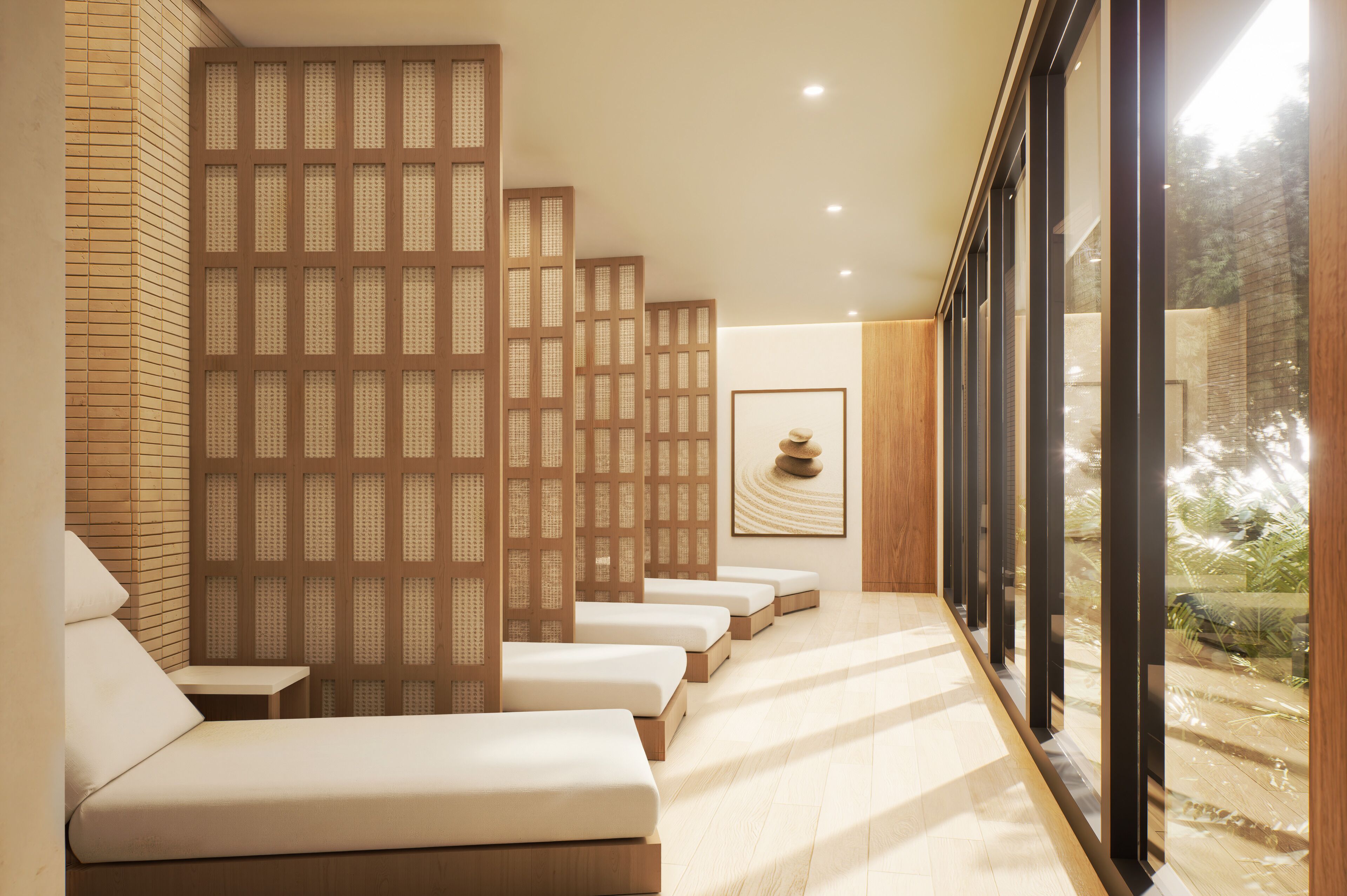 A spa area with a row of massage tables, wooden partitions, and a framed artwork on the wall.