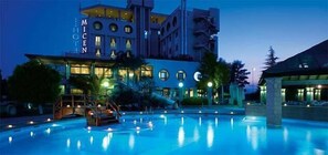 A hotel with a swimming pool, a well-lit facade, and a modern architectural design. - Miceneo Palace Hotel (Scanzano Jonico)