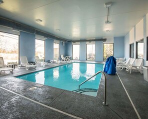 Relax by the pool surrounded by comfortable lounge chairs and tables.