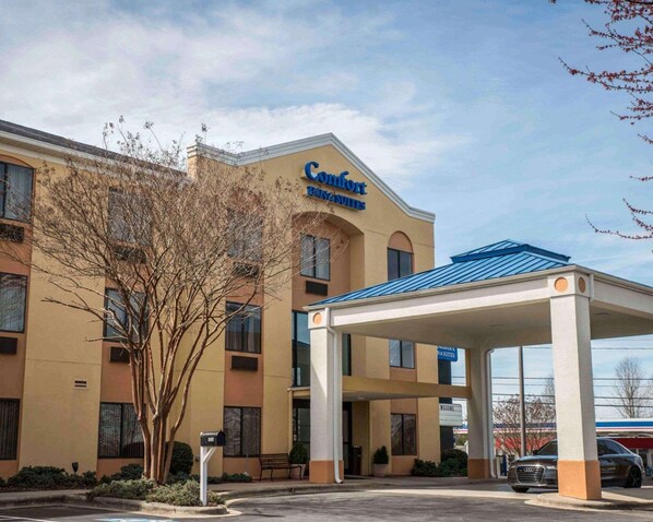 Welcome to Comfort Suites, featuring a modern architectural design with a flat facade and sheltered entrance.