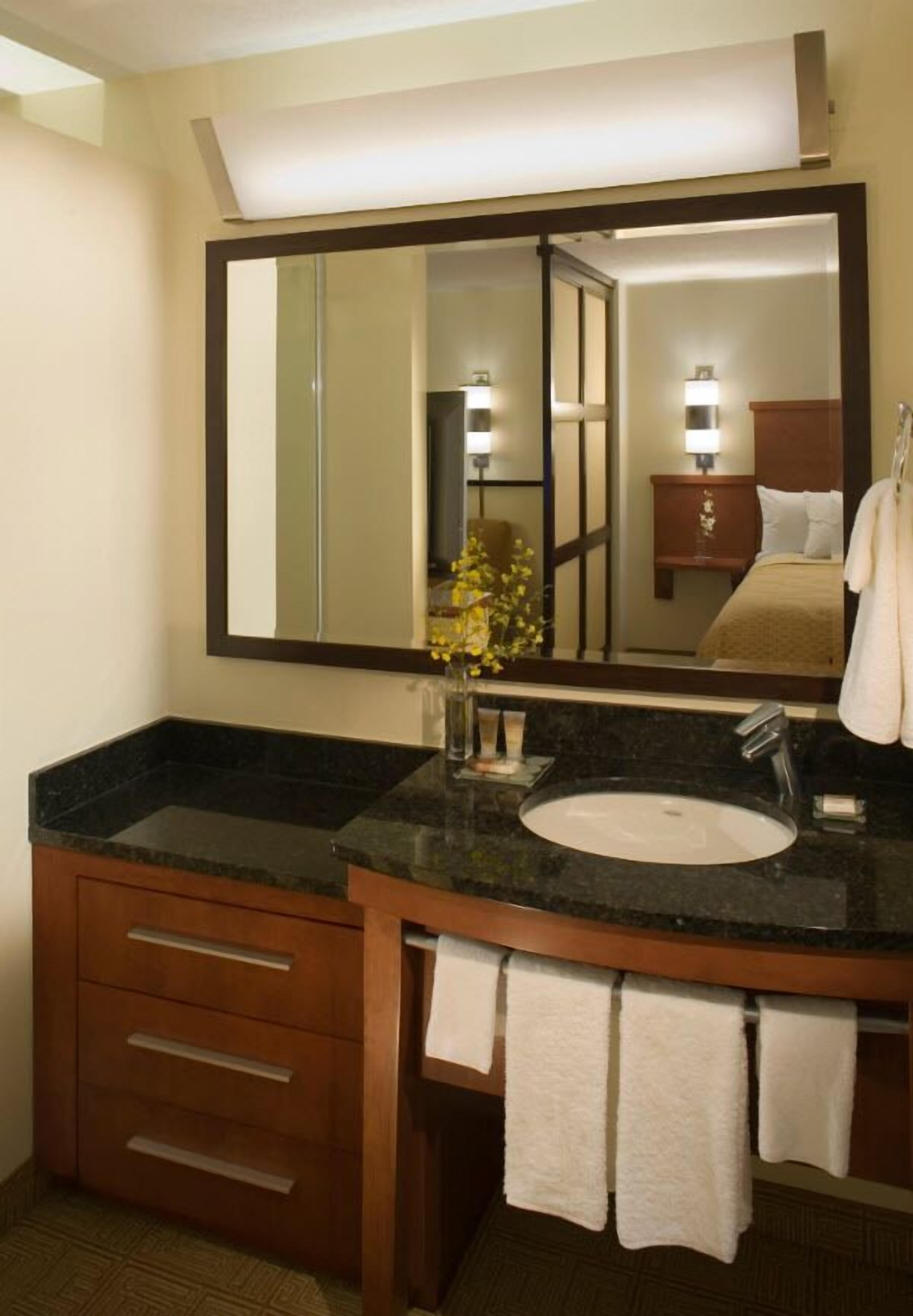 combined shower/bathtub, designer toiletries, hair dryer, towels