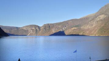 A calm lake with mountains in the background.